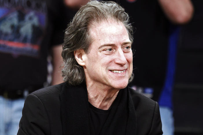 Comedian Richard Lewis attends an NBA basketball game in Los Angeles on Dec. 25, 2012. Lewis, an acclaimed comedian known for exploring his neuroses in frantic, stream-of-consciousness diatribes, has died at age 76.