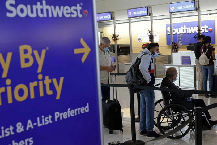 Passengers wait in line at Ronald Reagan Washington National Airport in 2021 in Virginia.