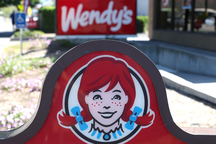 A sign is posted in front of a Wendy's restaurant on Aug. 10, 2022, in Petaluma, Calif. The company said Tuesday that it's planning to experiment with dynamic pricing.