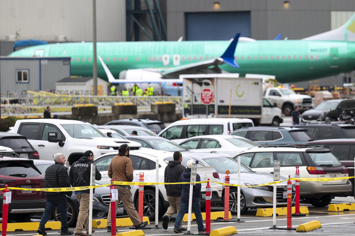 Workers and an unpainted Boeing 737 Max aircraft are pictured as the company's factory teams held a "Quality Stand Down" for the 737 program at Boeing's factory in Renton, Wash. on January 25, 2024.