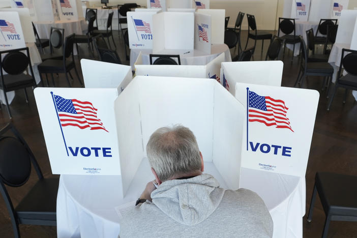 In a primary contest ahead of Super Tuesday, a voter fills out his ballot for the Michigan primary election on Feb. 27.