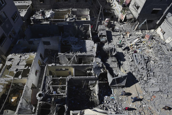 Palestinians inspect the rubble of destroyed buildings after an Israeli airstrike at the Nusseirat refugee camp, in central Gaza on Thursday.