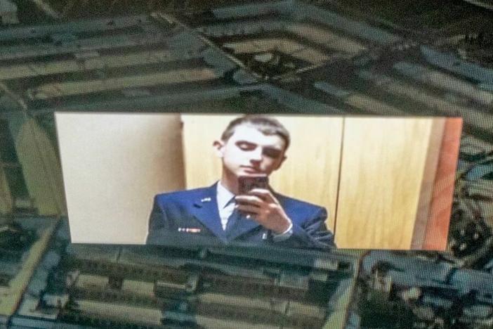 This photo illustration shows national guardsman Jack Teixeira reflected in an image of the Pentagon.