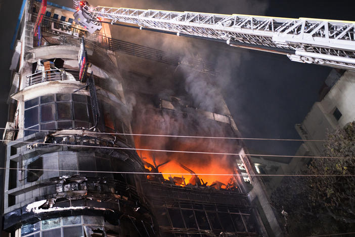Firefighters work to contain a fire that broke out at a commercial complex in Dhaka, Bangladesh, on Thursday.