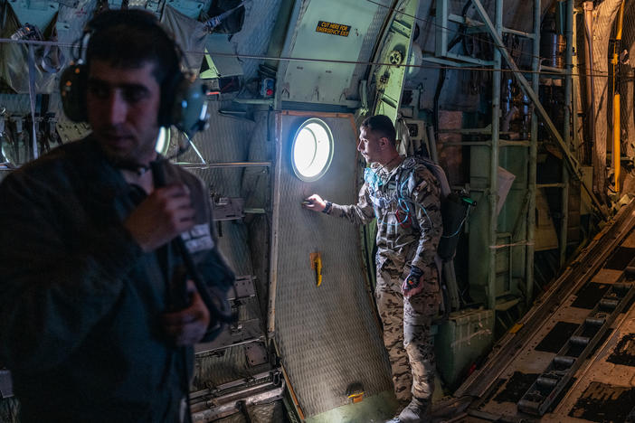 Jordanian air force personnel inside a C-130 aircraft after airdropping pallets of aid over Gaza on Thursday.