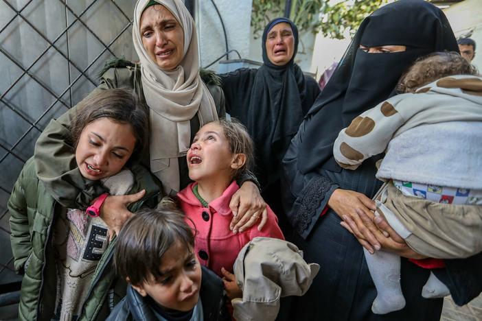 People mourn while receiving the bodies of victims of an Israeli strike on Rafah, in southern Gaza, on Saturday, March 2.