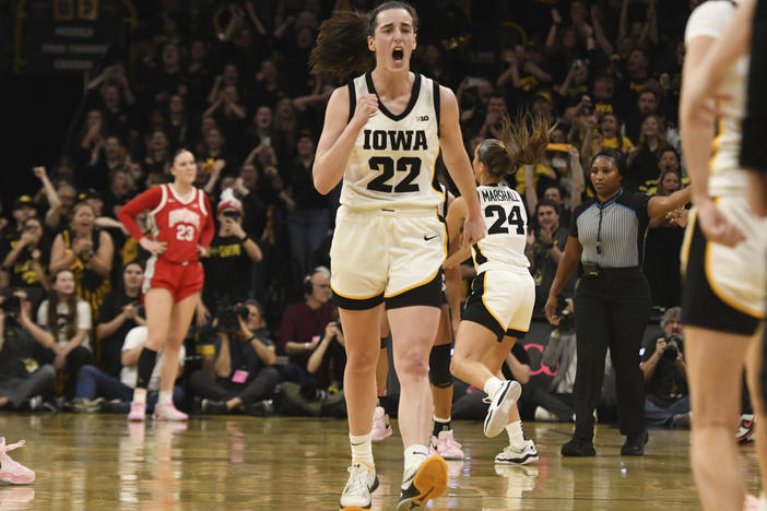 Iowa guard Caitlin Clark (22) celebrates after becoming the all-time leading scorer in NCAA Division I basketball during the first half of a college game against Ohio State, Sunday, March 3, 2024, in Iowa City, Iowa.