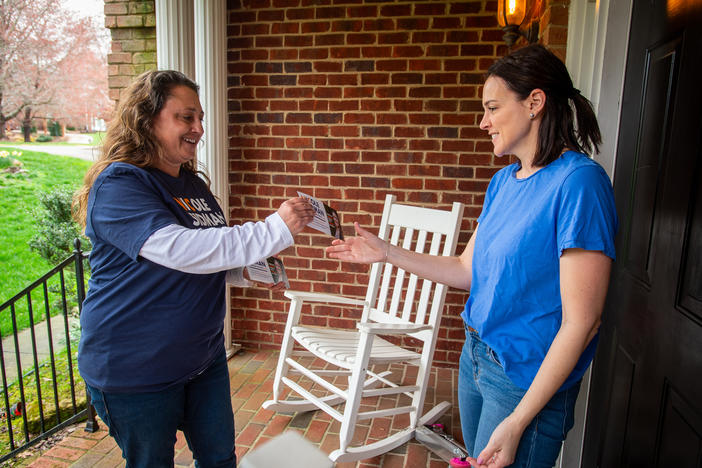 Nicole Sidman talks with prospective voter Rebekah Rubenstein on Sunday in Charlotte, N.C., ahead of Super Tuesday.