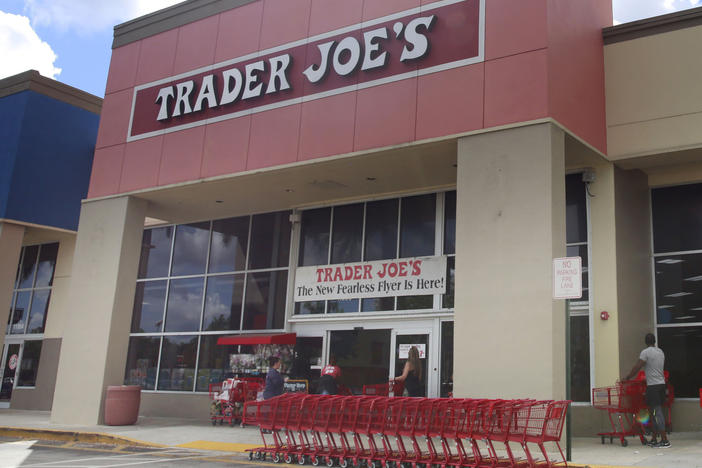 People stand in line waiting to enter Trader Joe's to buy groceries in Pembroke Pines, Fla., on March 24, 2020. More than 61,000 pounds of steamed chicken soup dumplings sold at Trader Joe's are being recalled for possibly containing hard plastic, U.S. regulators announced Saturday, March 2, 2024.