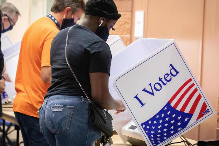 Voters cast their ballots in North Charleston, S.C., on Oct. 16, 2020. A new study says the turnout gap between white and nonwhite voters in the U.S. is growing fastest<em><strong> </strong></em>in jurisdictions that were stripped of a federal voting protection by a Supreme Court decision.