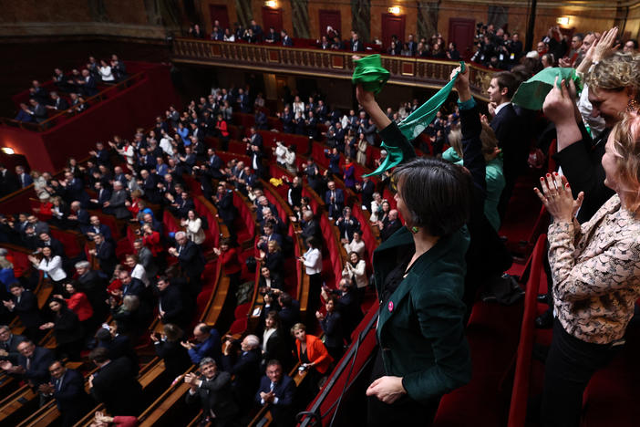 French lawmakers applaud after National Assembly President Yael Braun-Pivet announced the result of the vote during a joint session of parliament in the Palace of Versailles, southwestern of Paris, on Monday, to anchor the right to abortion in the country's constitution.