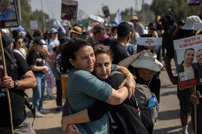 Meirav Leshem Gonen (left), whose daughter Romi is being held hostage in Gaza, embraces Sharon Alony Cunio, who was kidnapped and released from captivity along with her two children and whose husband, David, remains hostage, as the march to Jerusalem passes Kibbutz Sa'ad in southern Israel on Feb. 28.