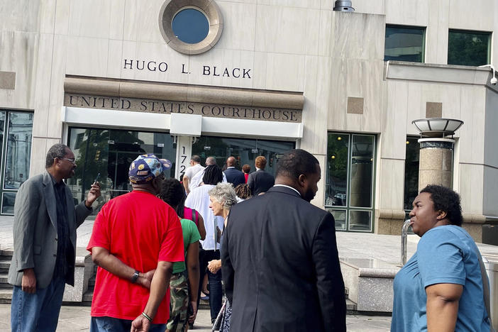 People wait outside the federal courthouse in Birmingham, Ala., in 2023 for a hearing to consider new congressional districts. Federal judges had ruled that the state's 2022 district map diluted Black voters' power.