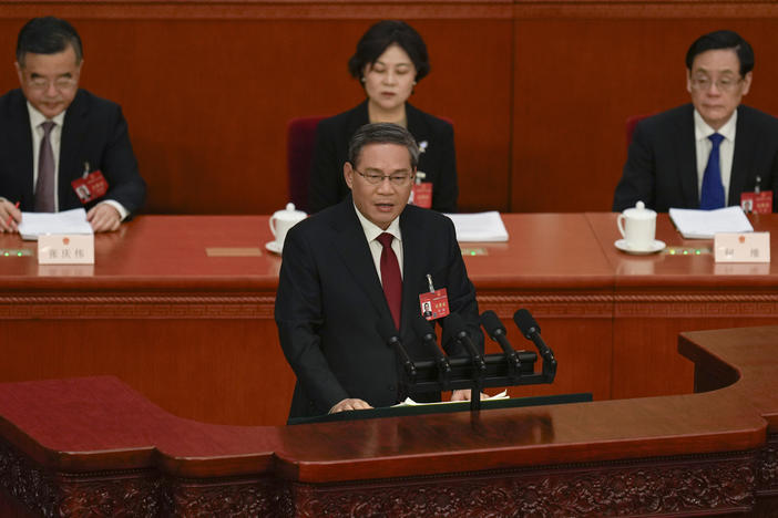 Chinese Premier Li Qiang, center, speaks during the opening session of the National People's Congress (NPC) at the Great Hall of the People in Beijing, China, Tuesday, March 5, 2024.