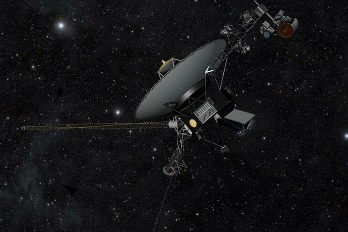 This artist's impression shows one of the Voyager spacecraft moving through the darkness of space.