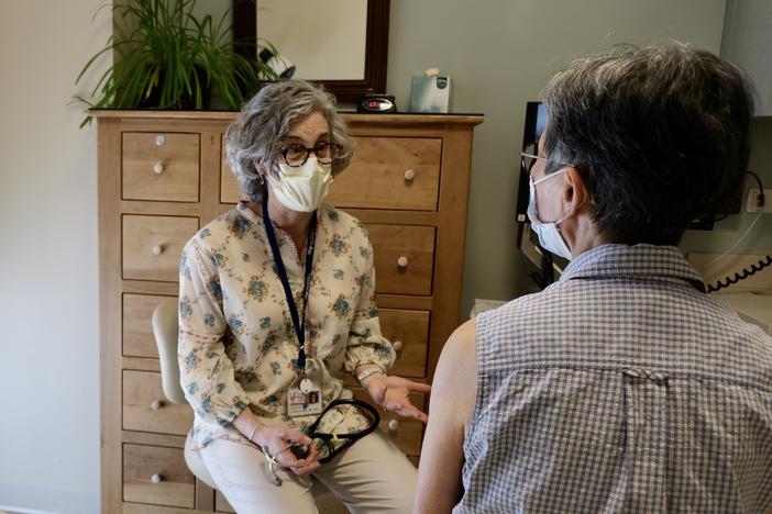 Dr. Louise Aronson, a geriatrician and author, speaks with a patient at UCSF's Osher Center for Integrative Health in San Francisco.