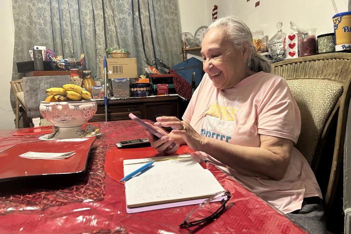 Kathryn Sellers makes calls to families on Wednesday, Feb. 14. Sellers is part of a program that provides students at Pittsburgh Arlington school with free van rides to and from school each day, as well as caring nanas who check in with families daily.