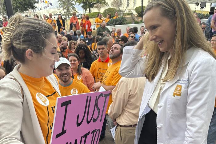 Hannah Miles of Birmingham speaks with Dr Dr. Mamie McLean outside the Alabama Statehouse in Montgomery, Ala. on Feb. 28, 2024. They were among patients and doctors urging Alabama lawmakers to take action to get IVF services in the state. Fertility clinics paused some services in the wake of a state court ruling related to whether embryos are children under a state law.
