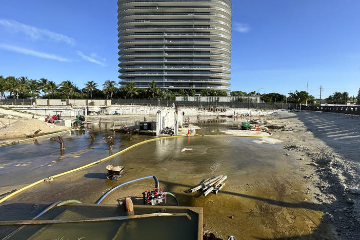 What remains on the site of the Champlain Towers South condo building is shown, June 15, 2023, in Surfside, Fla. The swimming pool deck of a beachfront South Florida condominium that collapsed in 2021, killing 98 people, failed to comply with the original building codes and standards.