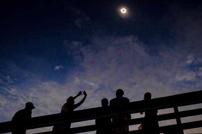 Eclipse gazers enjoying totality on August 21, 2017, in Isle of Palms, S.C. Eclipse experts say partial eclipses aren't nearly as dramatic.