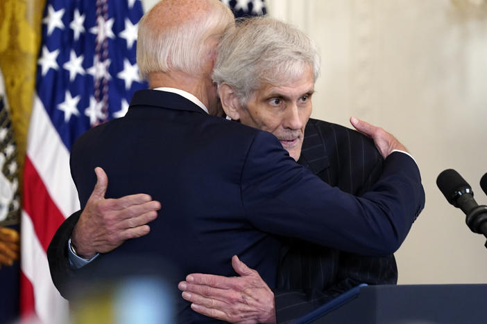 President Biden hugs Steven Hadfield during an event on prescription drug costs at the White House on Aug. 29, 2023. Hadfield, whose prescription costs were dramatically lowered by Biden's signature Inflation Reduction Act, is among the White House guests for Thursday night's State of the Union address.