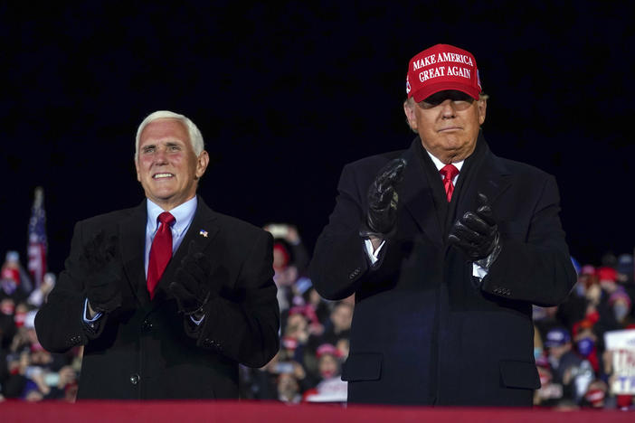 In this file photo, then-President Donald Trump arrives for a campaign rally at Gerald R. Ford International Airport, Nov. 2, 2020, in Grand Rapids, Mich., with then-Vice President Mike Pence.