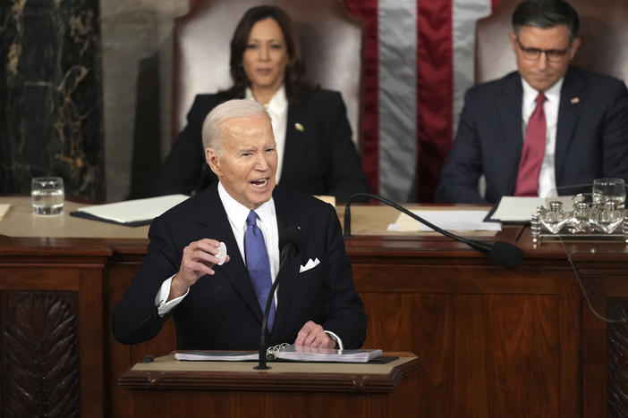 President Joe Biden holds a Laken Riley button as he delivers the State of the Union address to a joint session of Congress at the U.S. Capitol, Thursday March 7, 2024.
