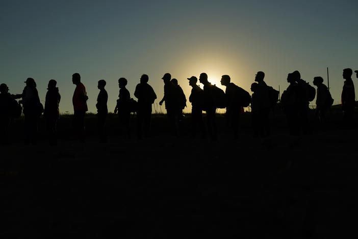 Migrants who crossed the Rio Grande and entered the U.S. from Mexico are lined up for processing by U.S. Customs and Border Protection on Sept. 23, 2023, in Eagle Pass, Texas. On March 8, 2024, a federal judge in Texas upheld a key piece of President Joe Biden's immigration policy that allows a limited number of migrants from four countries to enter the U.S. on humanitarian grounds.
