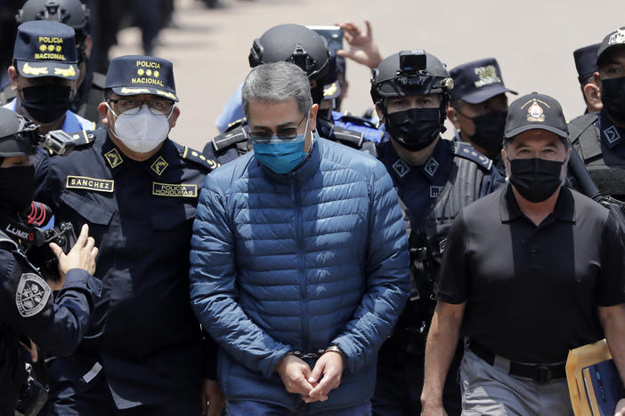 Former President of Honduras Juan Orlando Hernández is escorted by Honduran police to be extradited to the United States to face charges related to drug traffickers, on April 21, 2022, in Tegucigalpa, Honduras.