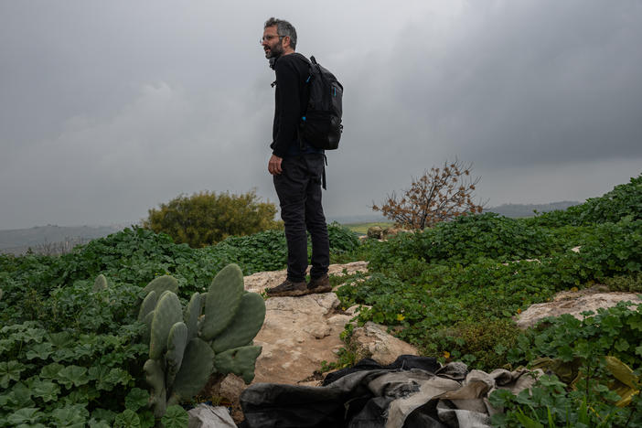 Nadav Weiman, deputy director of Breaking the Silence, walks through the abandoned Palestinian village of Zanuta in the occupied West Bank on Feb. 19.