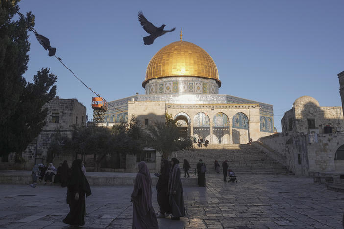 Muslims walk next to the Dome of Rock Mosque at the Al-Aqsa Mosque compound in Jerusalem's Old City, Sunday, March 10, 2024.