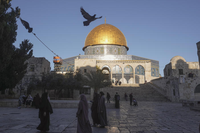 People walk next to the Dome of Rock Mosque at the Al-Aqsa Mosque compound in Jerusalem's Old City on Sunday.