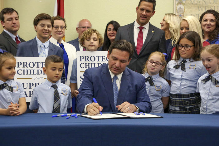 Florida Gov. Ron DeSantis signs the Parental Rights in Education bill, also known as the "Don't Say Gay" bill, at Classical Preparatory School, March 28, 2022, in Shady Hills, Fla. Students and teachers will be able to speak freely about sexual orientation and gender identity in Florida classrooms, provided it's not part of instruction, under a settlement reached Monday, March 11, 2024.