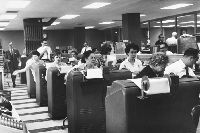 Employees of Goodbody & Co. work at the stock brokerage's headquarters in Manhattan, N.Y., circa 1965.