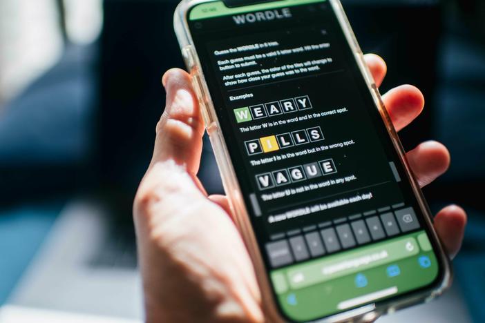 The word game Wordle is shown on a mobile phone in 2022. The <em>New York </em><em>Times </em>is accusing some Wordle clone creators of copyright infringement violations.