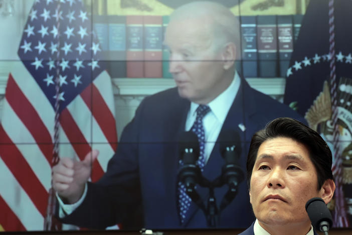 Robert Hur, the special counsel who led an investigation into President Biden's handling of classified documents, testifies alongside video of Biden to the House Judiciary Committee on Tuesday in Washington, D.C.