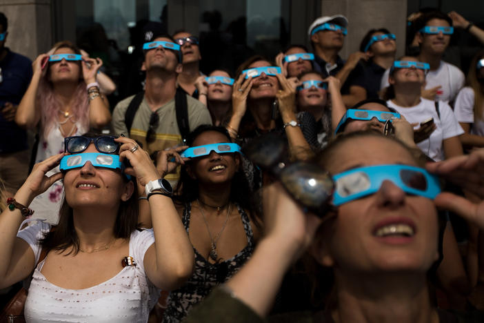 People view a total solar eclipse at from the observatory at Rockefeller Center in New York City on Aug. 21, 2017.