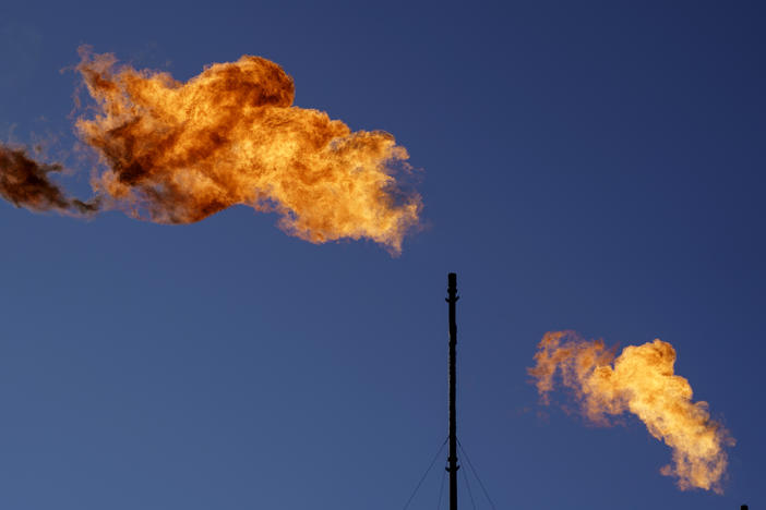 Flares burn off methane and other hydrocarbons at an oil and gas facility in Lenorah, Texas in 2021. New research shows drillers emit about three times as much climate-warming methane as official estimates.