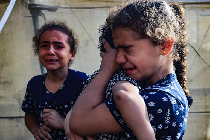 Children react during the funeral of the Faojo family, killed in an Israel strike on Rafah in the southern Gaza Strip on Nov. 11, 2023. Roughly 600,000 children are sheltering in Rafah, where a spiraling humanitarian crisis is playing out due to the war between Israel and Hamas.