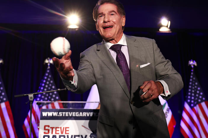 Republican Senate candidate Steve Garvey, a former Los Angeles Dodgers baseball player, tosses a baseball to supporters at his election night watch party on March 5 in Palm Desert, Calif.