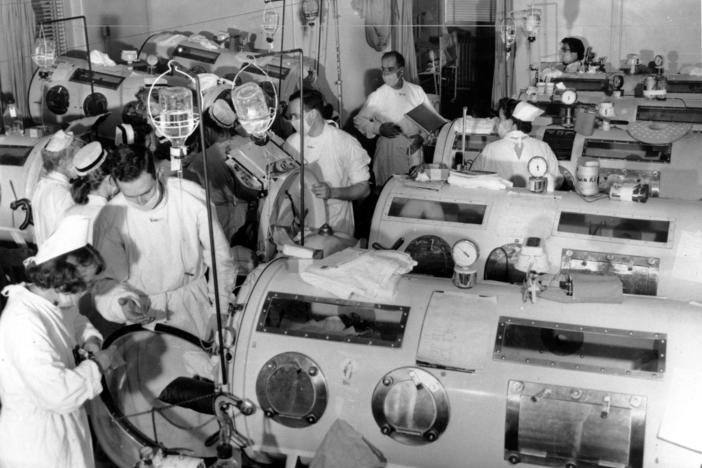 Paul Alexander, who held a Guinness World Record for living the longest with the help of an iron lung, has died. Here, medical staff stand among iron lung machines in an emergency polio ward at Haynes Memorial Hospital in Boston, Mass., on Aug. 16, 1955, when the city's polio epidemic hit a high of 480 cases.