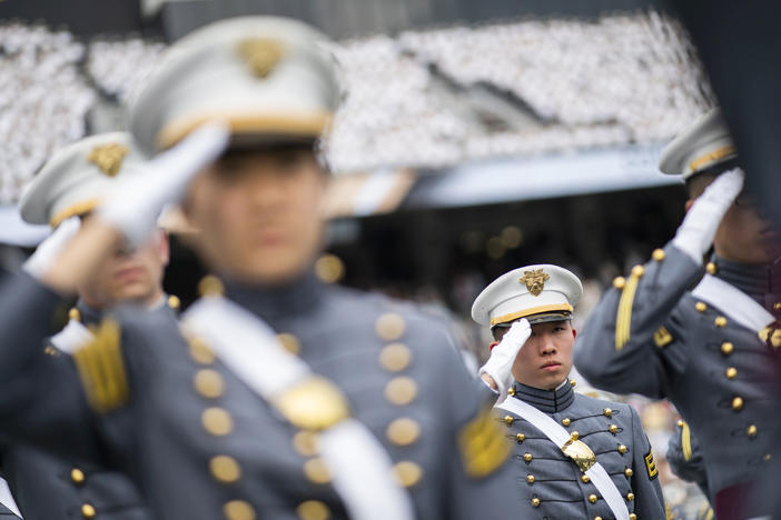 Cadets salute during the graduation ceremony at the U.S. Military Academy in 2021. A change to West Point's mission statement has sparked outrage among some conservatives online.