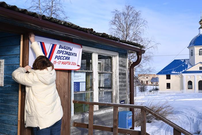 A member of a local election commission prepares a polling station with a sign that reads "Election of the President of Russia March 15-17 2024" for early voting in the village of Sennaya Guba, Republic of Karelia, on March 10.