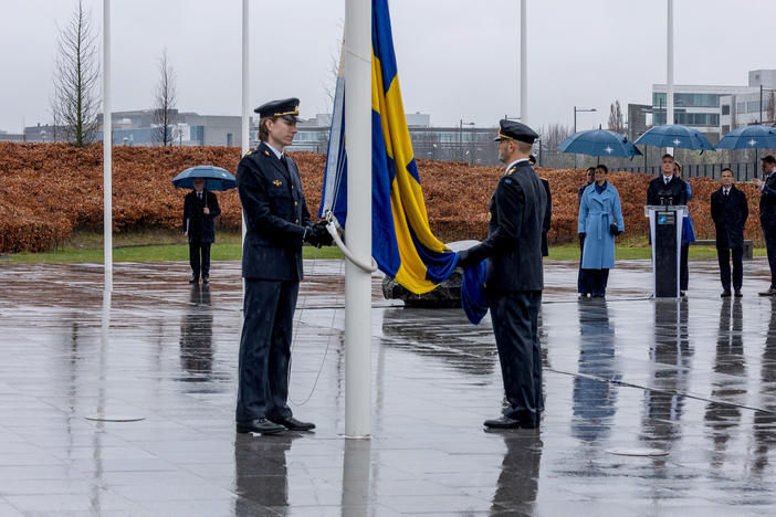 Military personnel raise the Swedish flag during Sweden's NATO accession ceremony at NATO headquarters during a flag-raising ceremony outside NATO headquarters this week.  Expanding the number of NATO members is one way the military alliance is trying to strengthen itself after Russia's invasion of Ukraine.