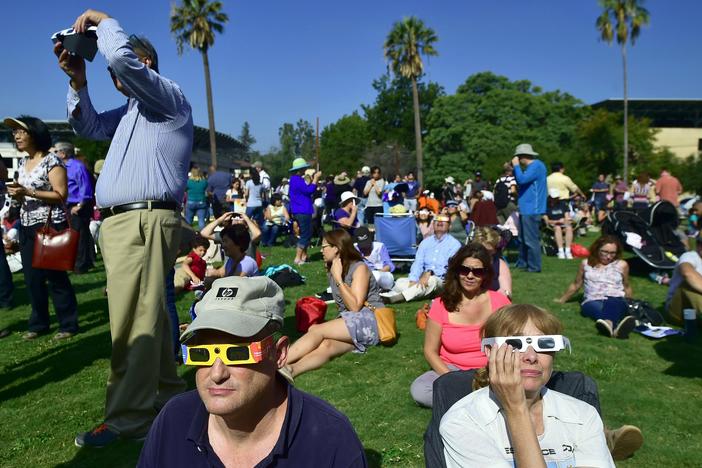 Eclipse enthusiasts wearing protective glasses view a partial eclipse from Beckman Lawn at Caltech in Pasadena, Calif., on Aug. 21, 2017. Another solar eclipse is just weeks away.