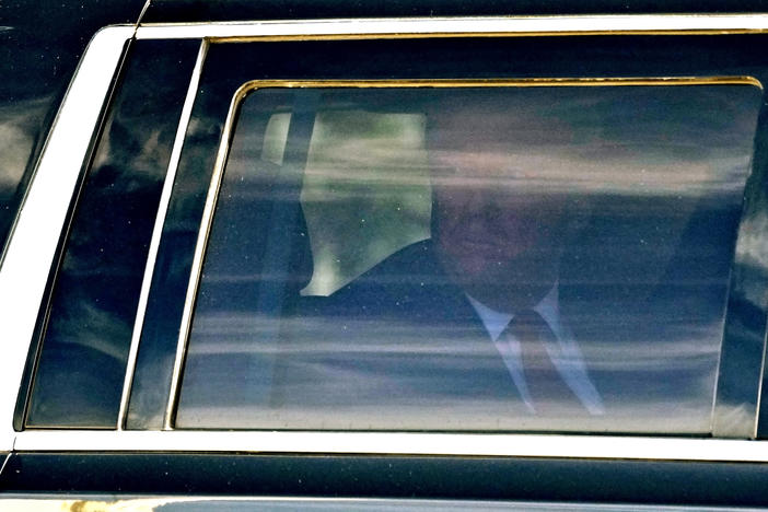 Former President Donald Trump waves to supporters as he leaves federal courthouse in Fort Pierce, Fla., on Thursday.