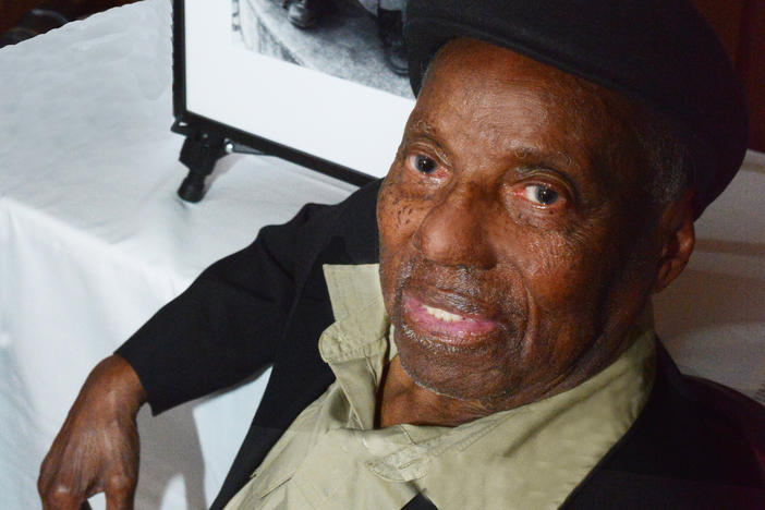 David Johnson in 2023 with one of his photographs, "Clarence," at an award luncheon at UC Berkeley honoring the photographer.
