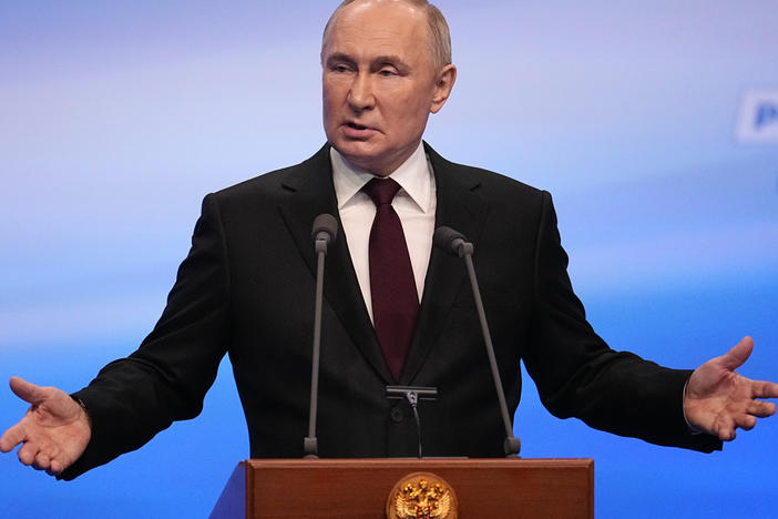 Russian President Vladimir Putin gestures while speaking on a visit to his campaign headquarters after a presidential election in Moscow, Russia, early Monday.