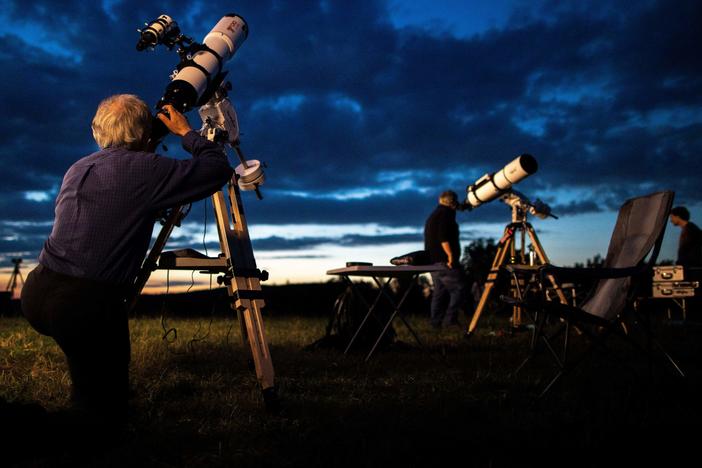 People await the partial lunar eclipse over Vienna, on July 16, 2019. Astronomers say the comet 12P/Pons-Brooks will soon be visible to the naked eye.