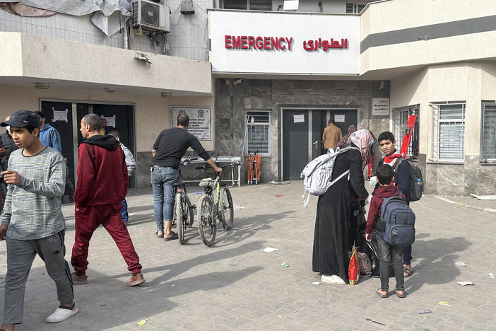 Displaced Palestinians gather in the yard of Gaza's Al-Shifa hospital on Dec. 10, 2023. The hospital, Gaza's largest, war raided by the Israeli military early on Monday.